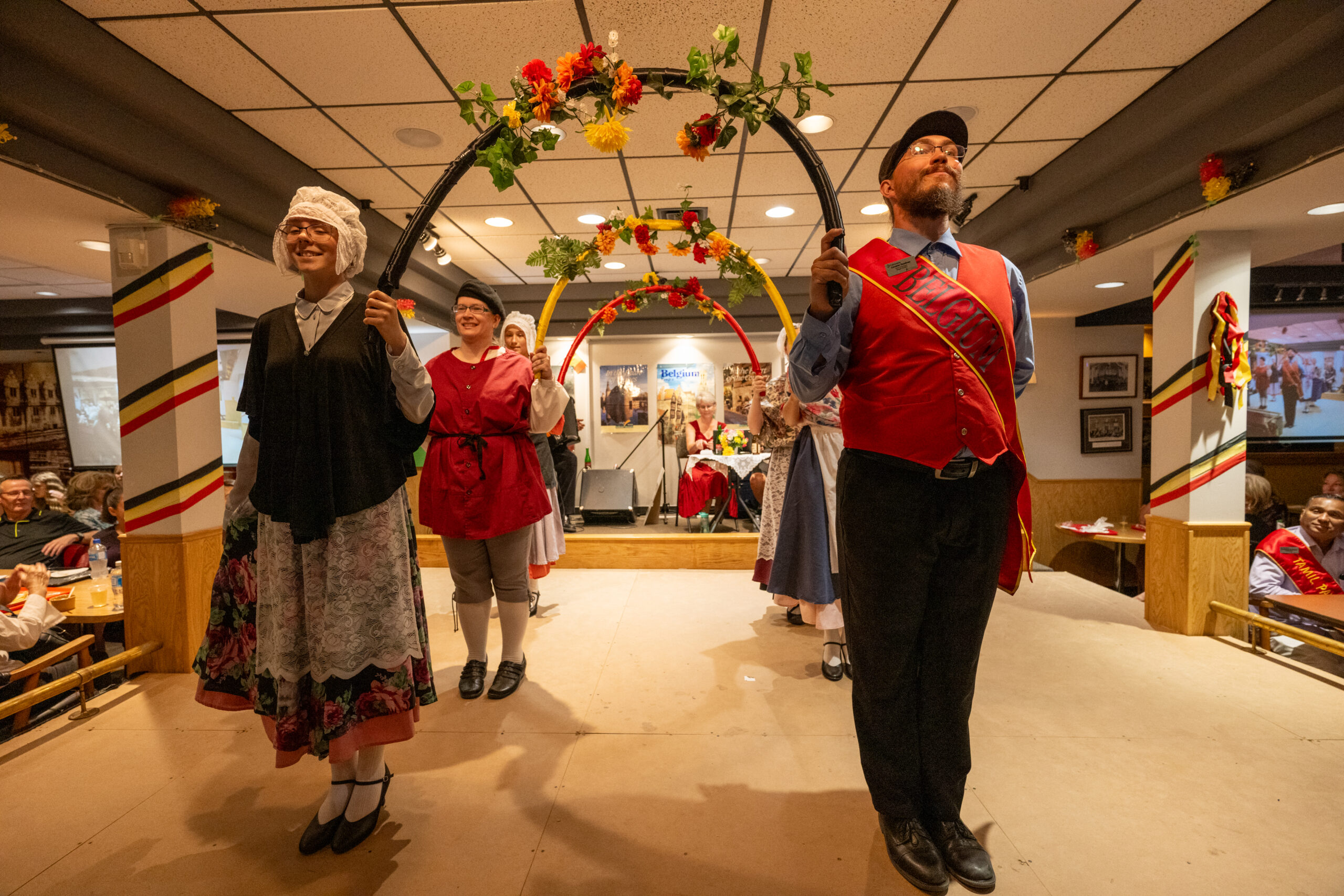 Belgian performers in traditional outfits posing