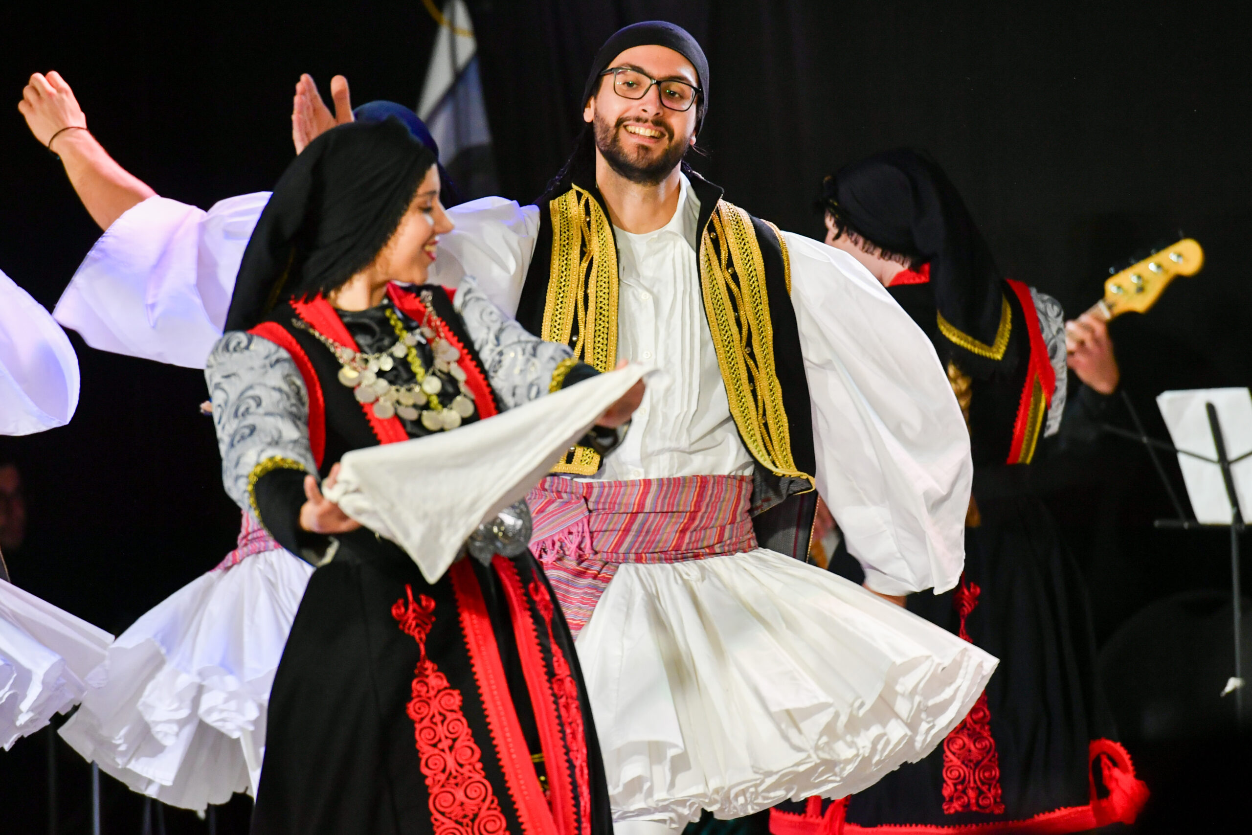 Greek dancers in traditional outfits performing